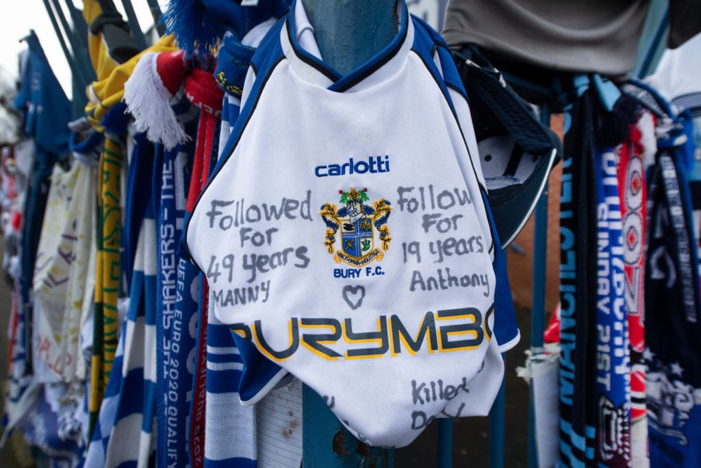 A Bury FC shirt left outside Gigg Lane after the club's expulsion from the Football League. Photo: Visionhaus via Getty Images.